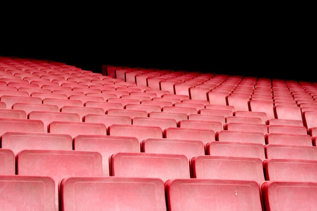 Rows of red seats in an empty theater auditorium